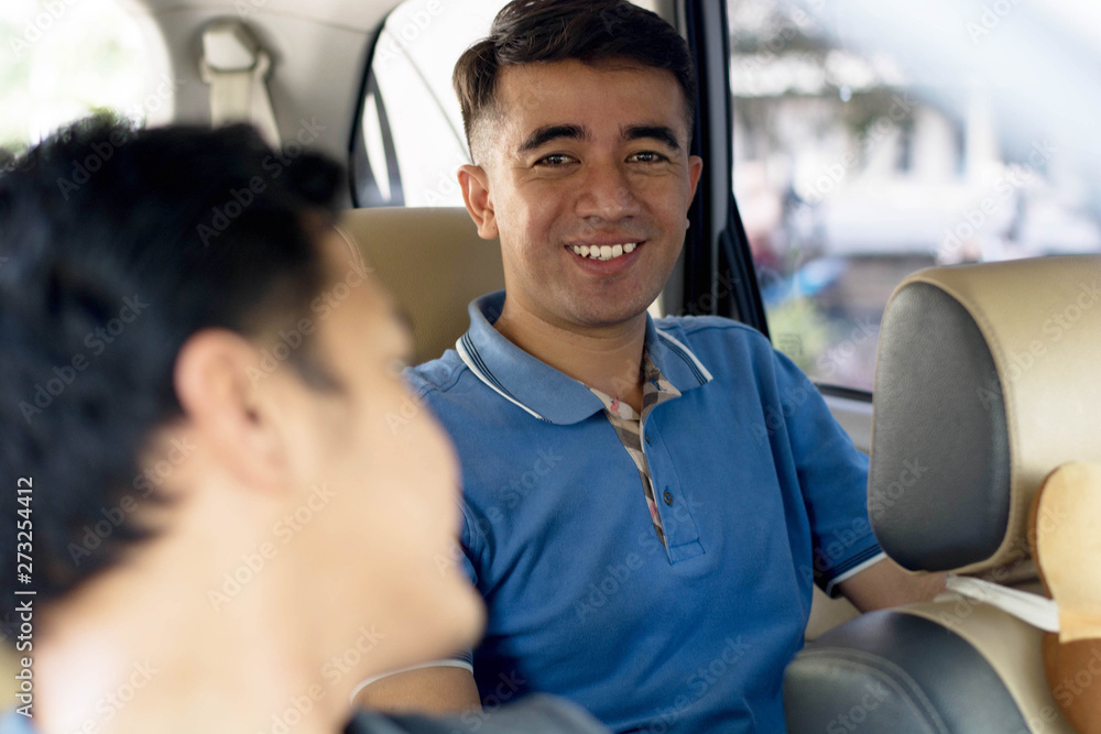 young handsome man looking at driver as passanger inside car young handsome man looking at driver as passanger inside car