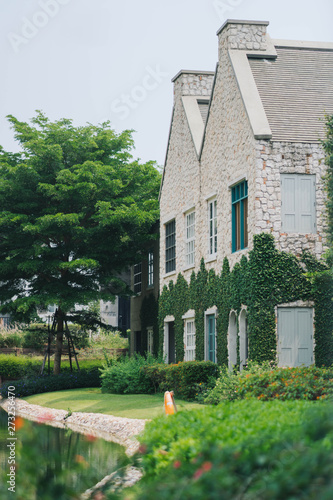 Wallpaper Mural Beautiful decoration of English country style building covered with green creeper plant Torontodigital.ca