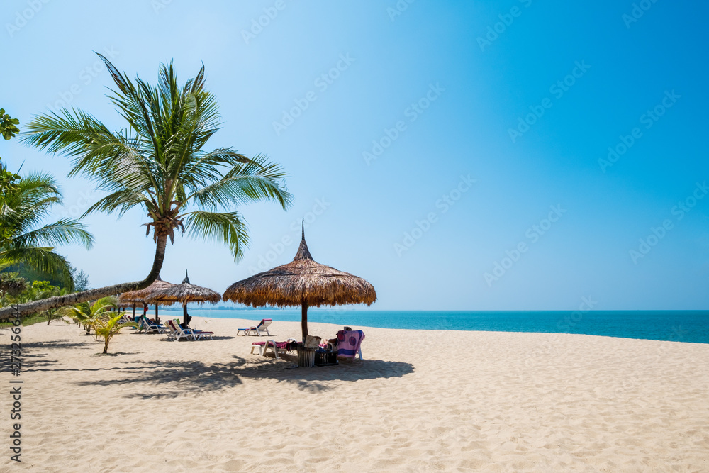 Beach chairs, umbrella and palms on sandy beach near sea. island in Phuket, Thailand. Travel inspirational, Summer holiday and vacation concept for tourism relaxing.