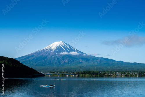 Fuji mountain and Kawaguchiko lake in morning, fog flow on the air and people do activity.