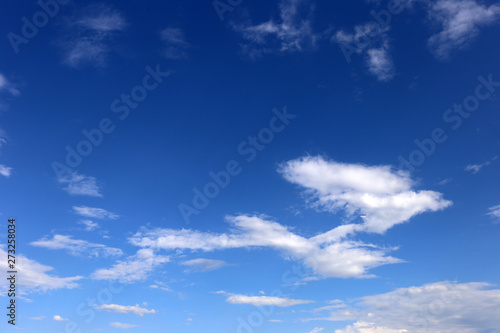 blue sky background with tiny clouds.