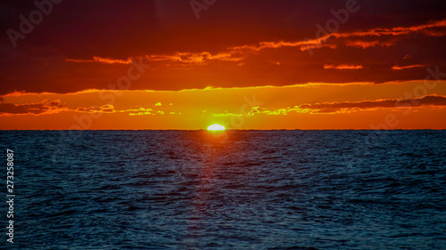 Dramatic fiery sunset over the sea landscape.