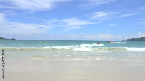 Jet ski moving into open sea while another boat coming from the side on the sunny blue sky day.