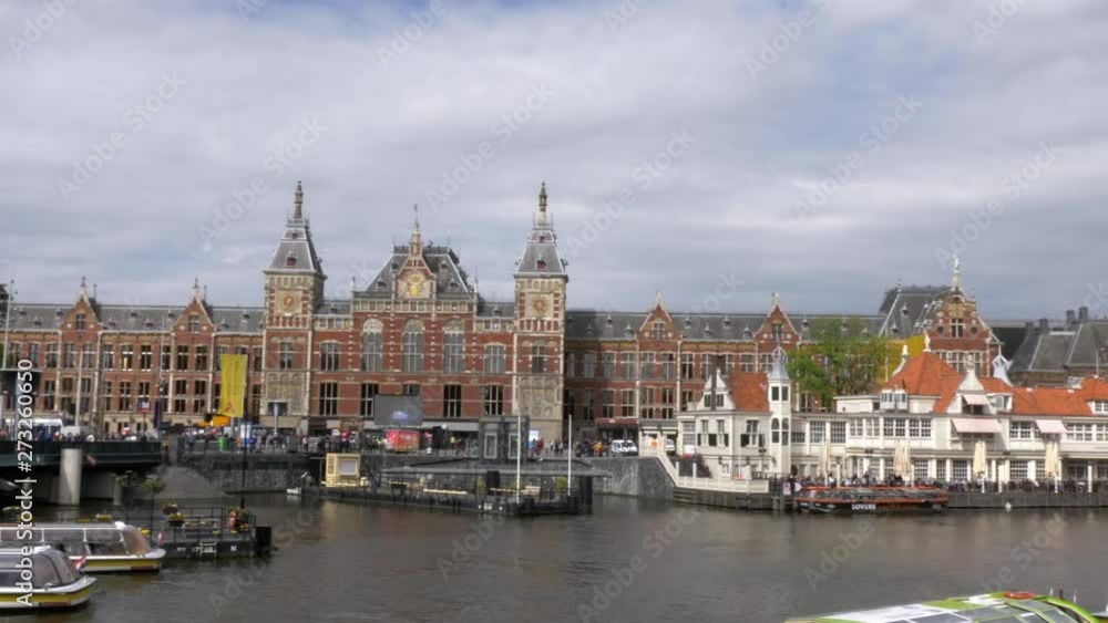 Central Station is a railway station in Amsterdam, wide shot on a cloudy day. Central Station is a railway station in Amsterdam, wide shot on a cloudy day.