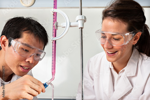 Asian boy and a girl trying to do experiments photo