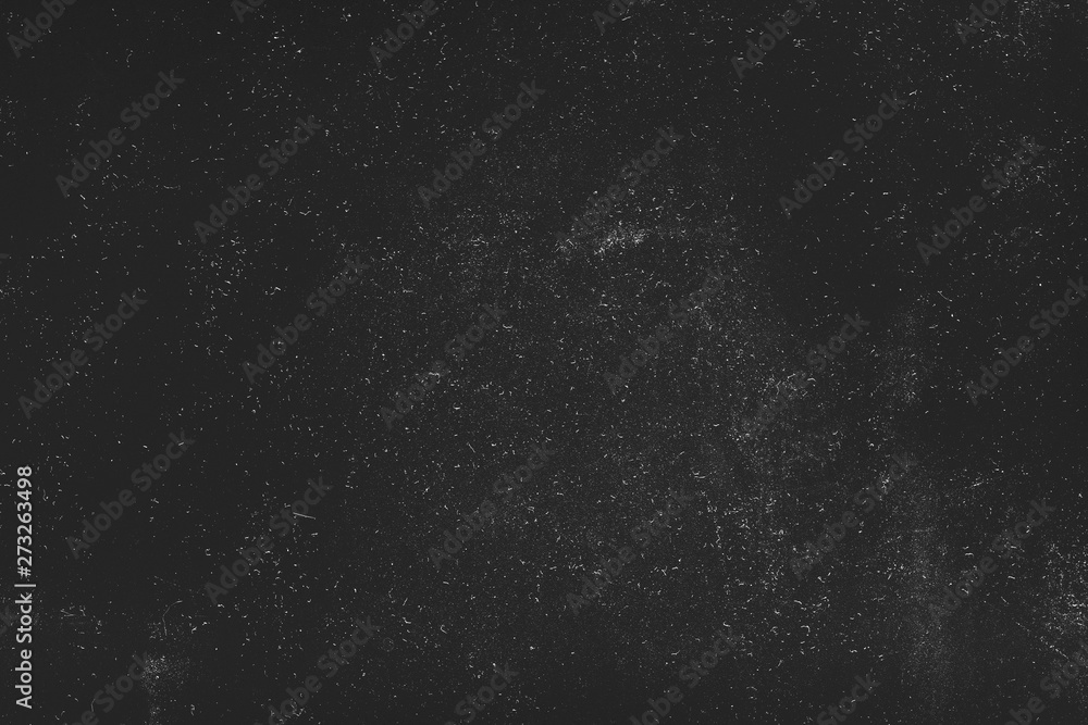 Night sky effect abstract background. White dust and scratches over black surface. Empty space.