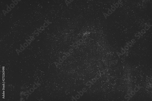 Night sky effect abstract background. White dust and scratches over black surface. Empty space.