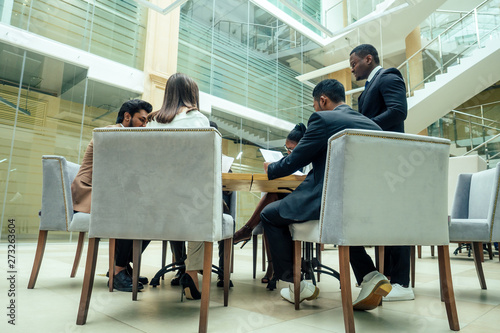 Photography well-dressed business afro american men making a report to subordinate employees