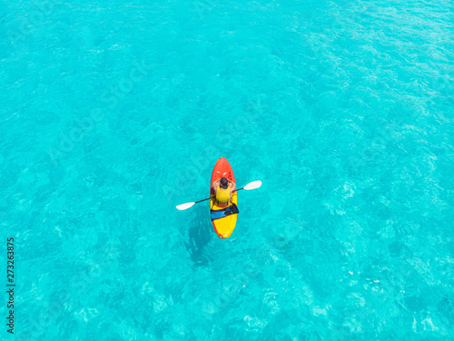 Kayak boat turquoise blue water sea. Aerial top view.