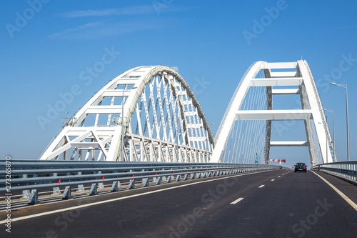 large white arches of the Crimean bridge across the Kerch Strait in Russia and the road across the bridge