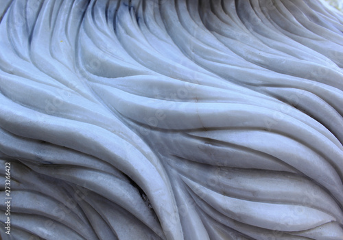 Carving patterns on the marble reliefs.