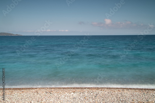 Fototapeta Naklejka Na Ścianę i Meble -  A wave breaking on the shore of stones in Saint Florent, Corsica, France