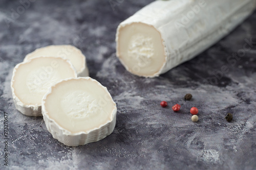 Fresh goat cheese with slices dark marple