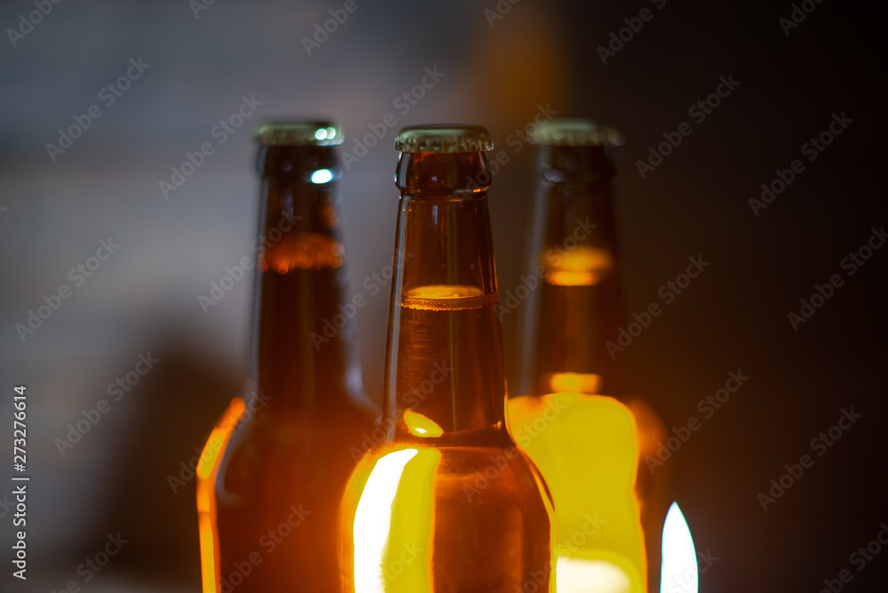 Group of glass beer bottles on dark background Group of glass beer bottles on dark background