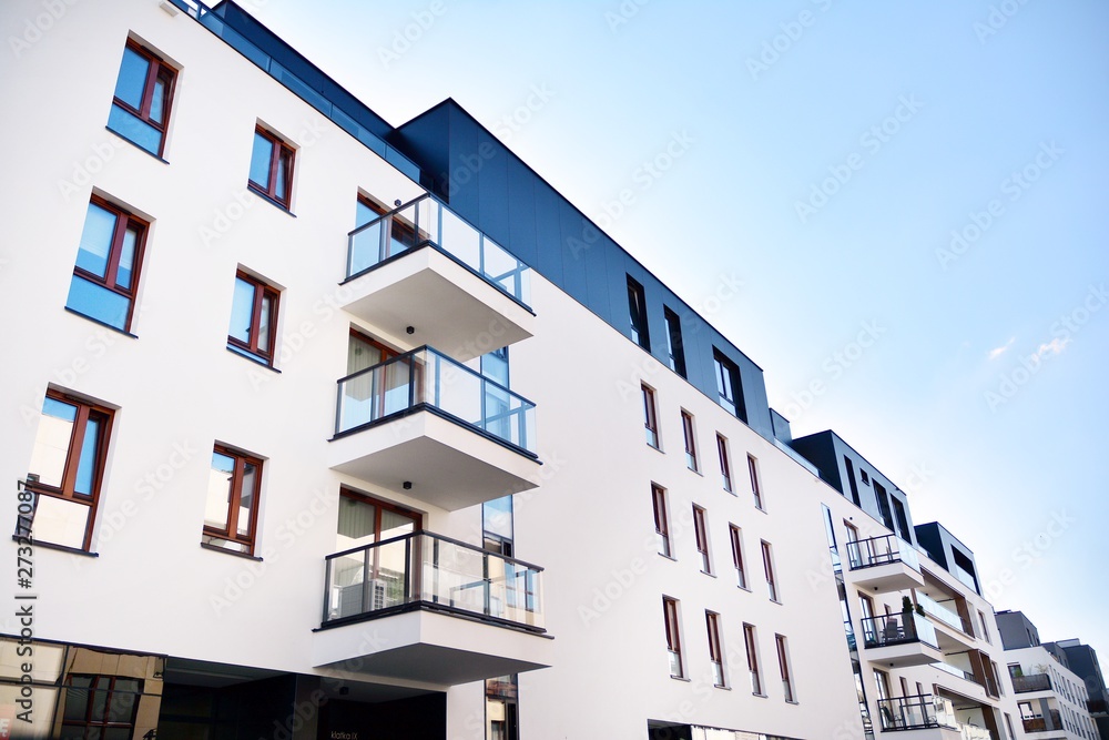 Multistory new modern apartment building. Stylish living block of flats.