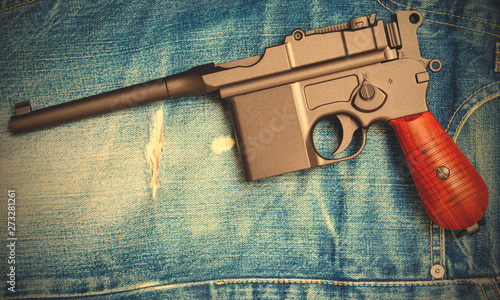 Mauser submachine gun on vintage jeans