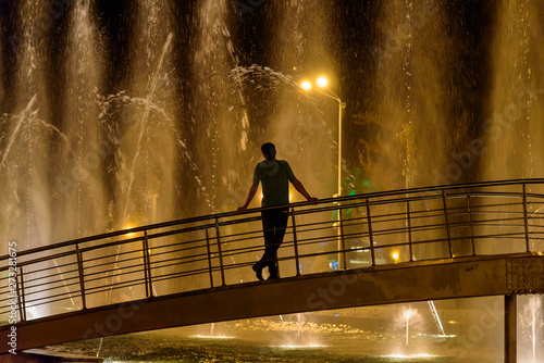 Human silhouette at the fountain at night