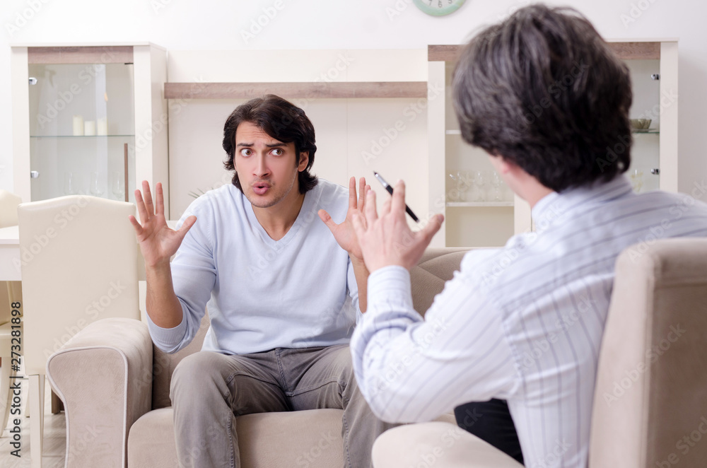 Young male patient discussing with psychologist personal problem Young male patient discussing with psychologist personal problem