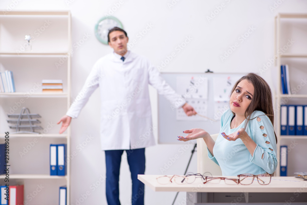 Fototapeta premium Young woman visiting male doctor oculist 