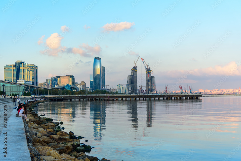 Naklejka premium view of the coast of the Caspian sea at sunset, urban landscape.