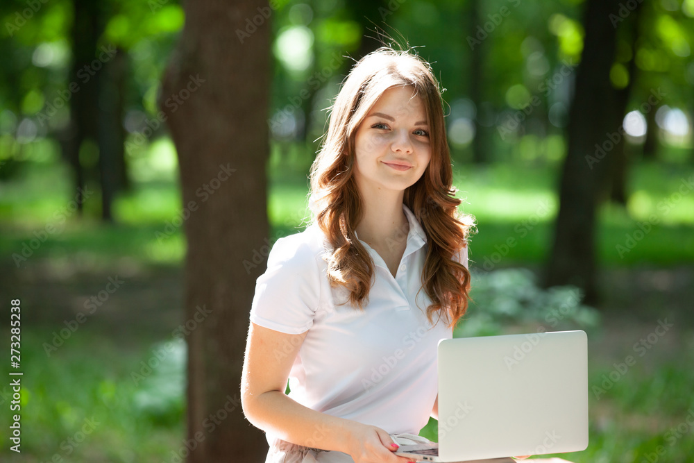 Gorgeous girl with short blond hair walks in the park. Cute girl looks happy and smiles. Gorgeous girl with short blond hair walks in the park. Cute girl looks happy and smiles.