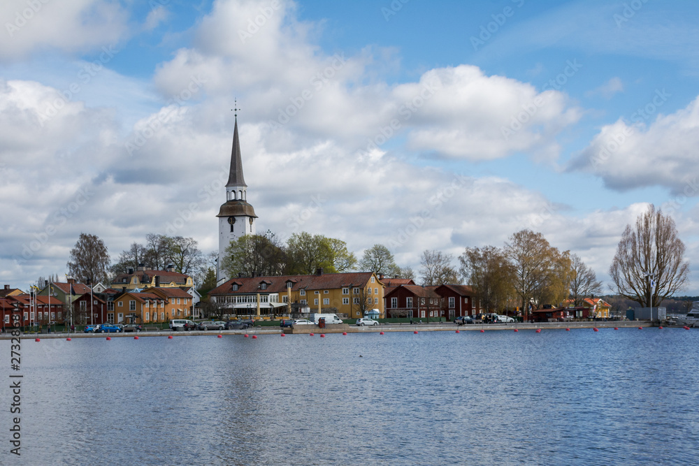 Central part of small and cosy swedish town Mariefred in Sodermanland with its harbour and high bell tower of local church (Mariefred Charterhouse) Panorama, urban landscape