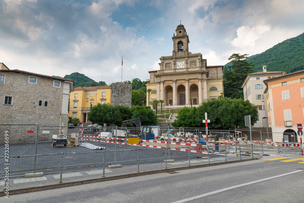Naklejka premium Urbanization works in the historic center of a Swiss city. Mendrisio and in the background the church of Santi Cosma e Damiano, square del Ponte