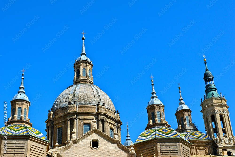 Top of the roman catholic cathedral of El Pilar against a clear blue sky. Zaragoza, Aragon, Spain