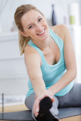 smiling girl practicing yoga indoors