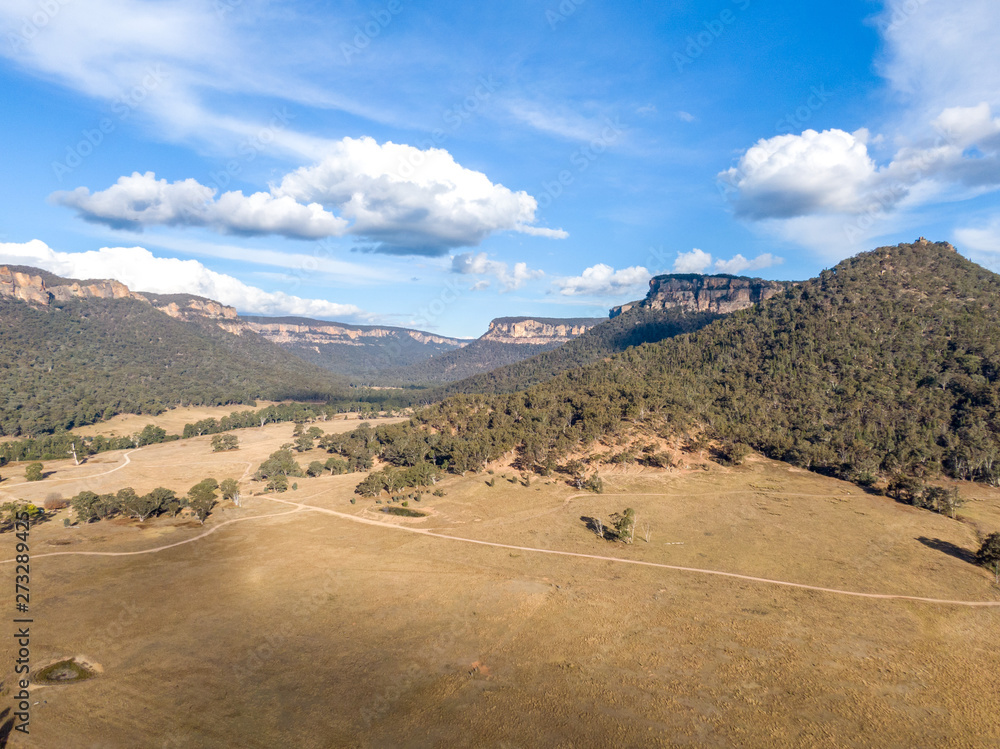 Aerial panoramic drone view of Wolgan Valley along the Wolgan River in the Lithgow Region of New South Wales, Australia. Part of the Blue Mountains near Sydney.