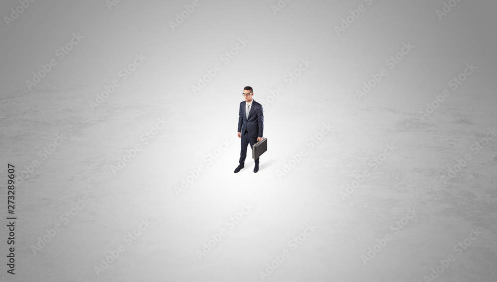 Young businessman standing alone in the middle of an empty space
Young businessman standing alone in the middle of an empty space