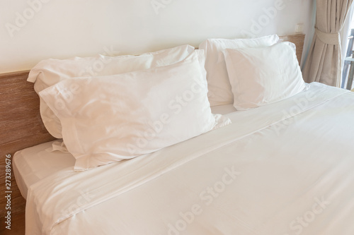 Comfortable soft white pillows on the bed.