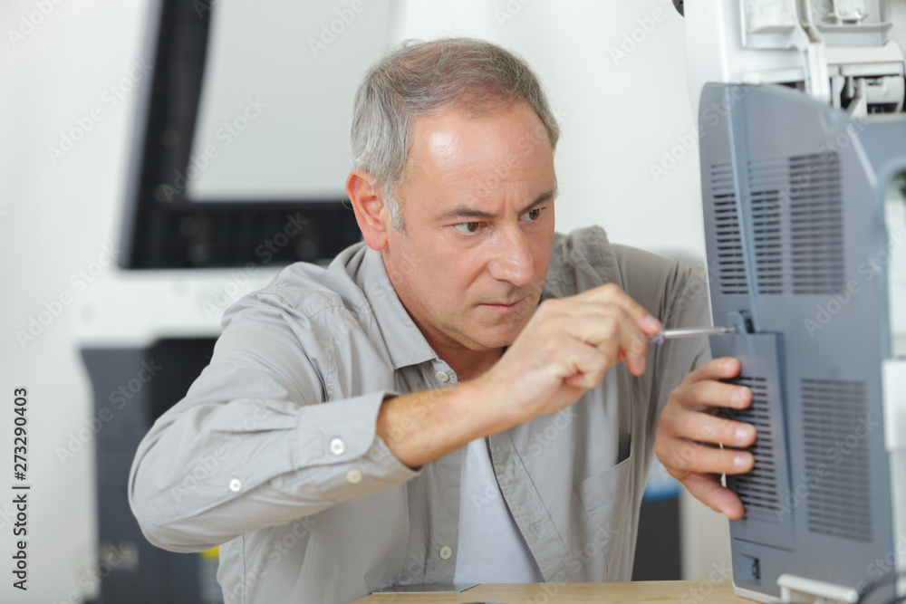 man technician repairing a printer at business place at work man technician repairing a printer at business place at work