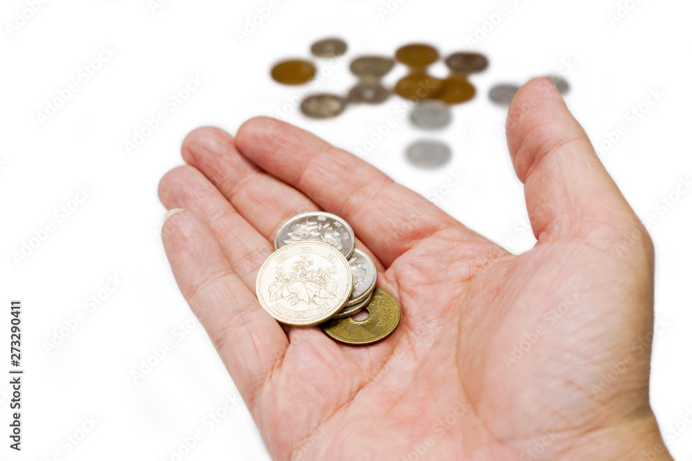Japan Yen currency coins on hand with blurry coins isolate on white background and make with paths. Japan Yen currency coins on hand with blurry coins isolate on white background and make with paths.