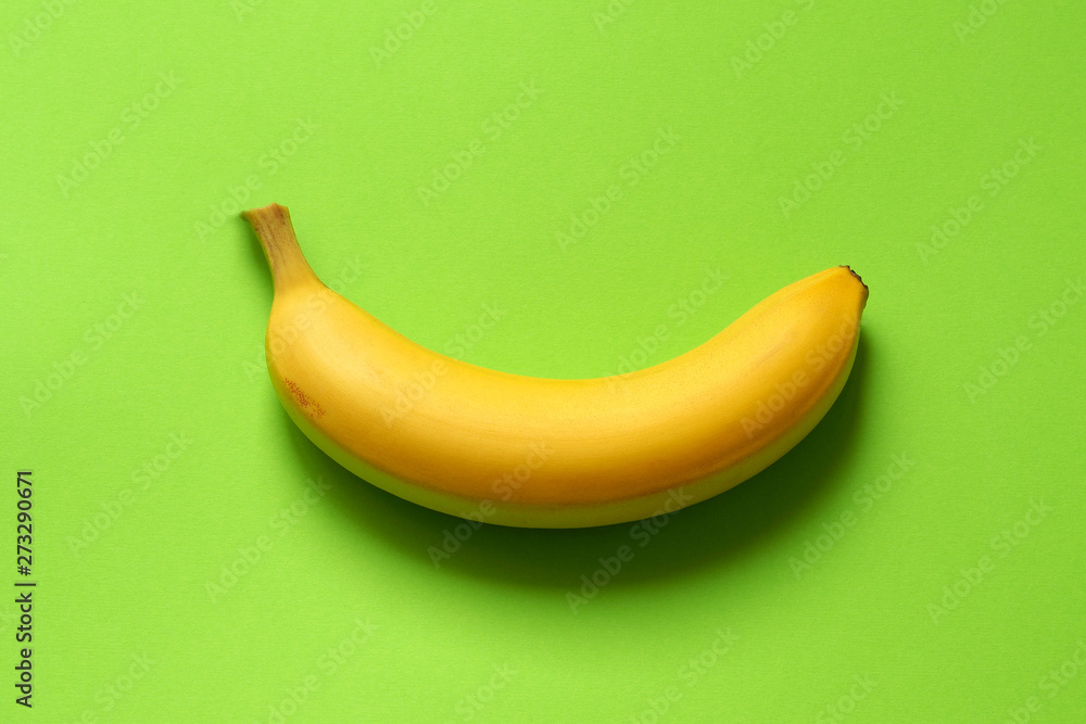 banana on green background. one ripe banana. banana on green background. one ripe banana.