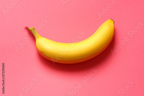 banana on red background. one ripe banana.