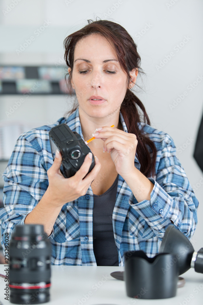 beautiful woman fixing camera beautiful woman fixing camera