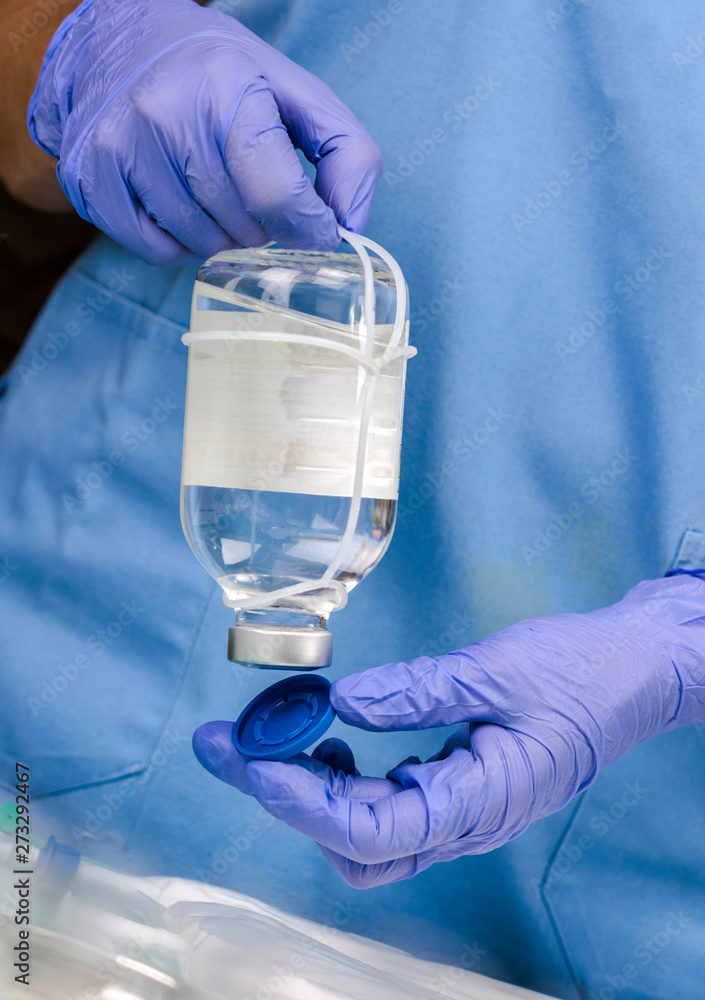 Nurse uncovers medicine bottle in a hospital, conceptual image Nurse uncovers medicine bottle in a hospital, conceptual image