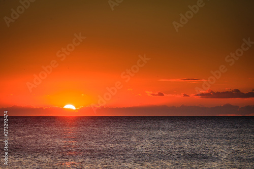 Sunset or sunrise over sea surface