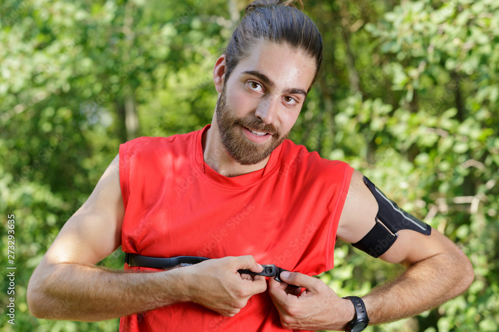 man running with heart rate monitor strapped across his chest man running with heart rate monitor strapped across his chest