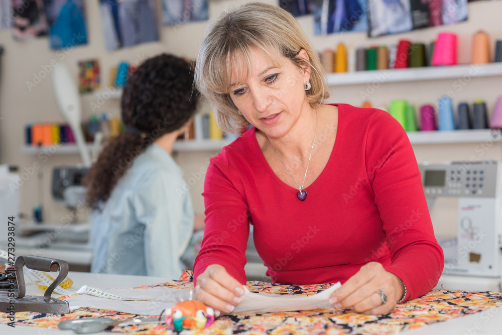 Fototapeta premium contemporary fashion designer with the tissue samples in creative office