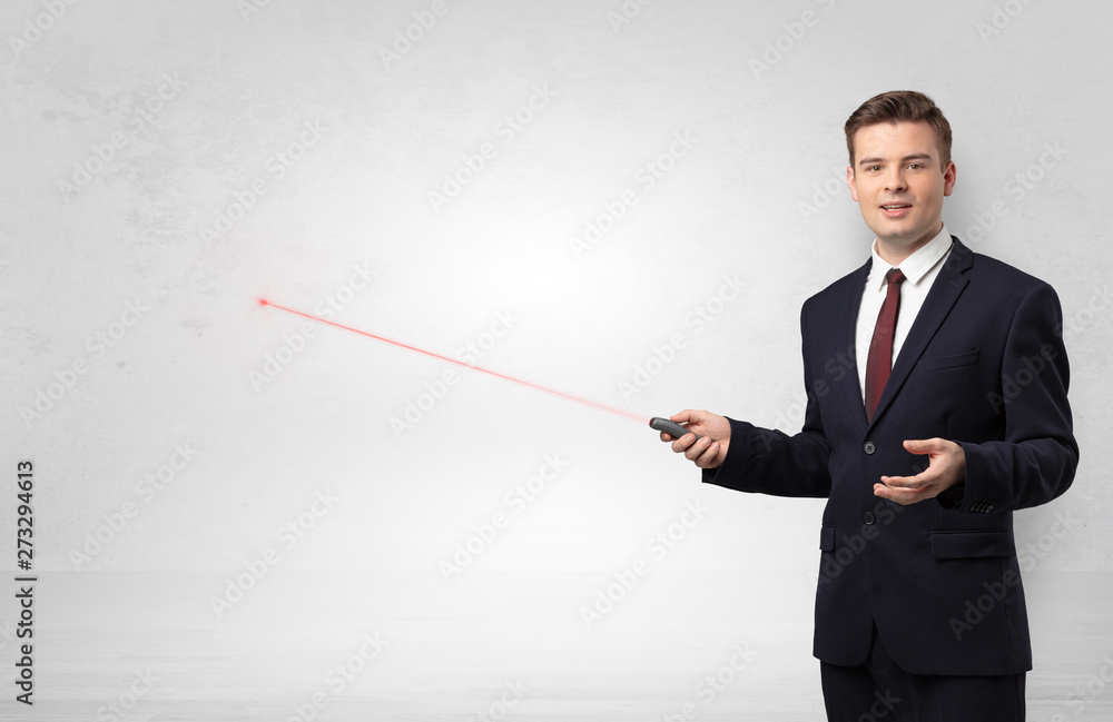 Young businessman with laser pointer and copyspace white wall
Young businessman with laser pointer and copyspace white wall