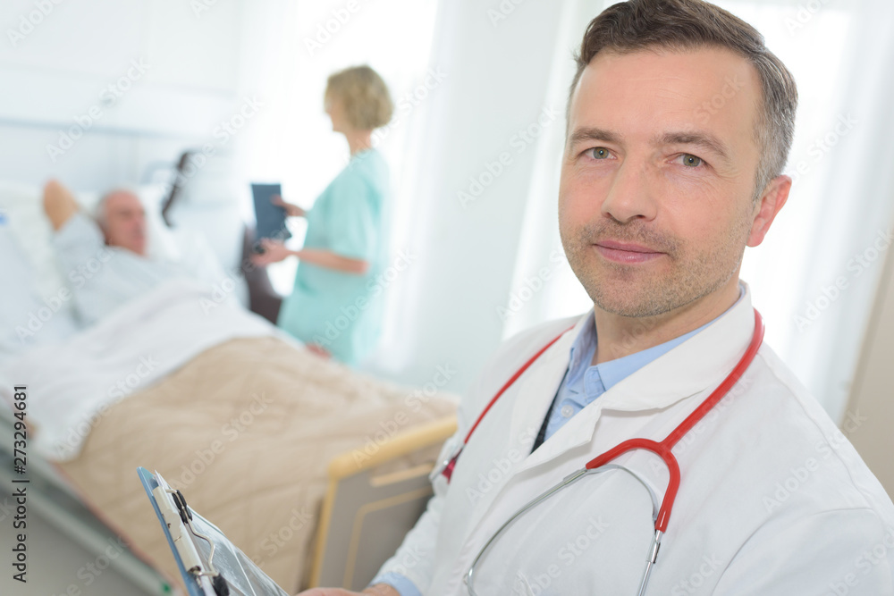 portrait of doctor in patients hospital room portrait of doctor in patients hospital room