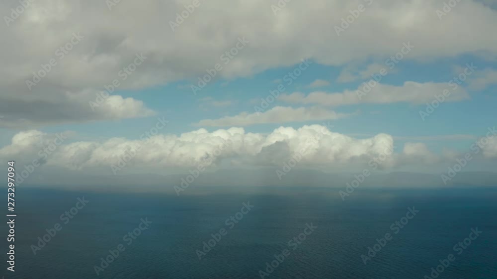 Sea surface with waves against the blue sky with clouds, aerial view. Water cloud horizon background. Blue sea water with small waves against sky. Sea surface with waves against the blue sky with clouds, aerial view. Water cloud horizon background. Blue sea water with small waves against sky.