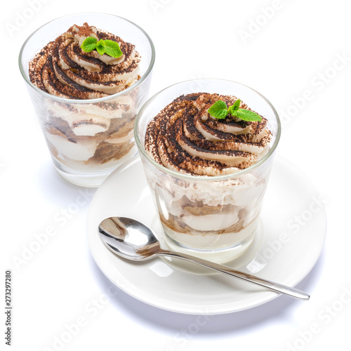 Classic tiramisu dessert in a glass on plate with spoon isolated on a white with clipping path