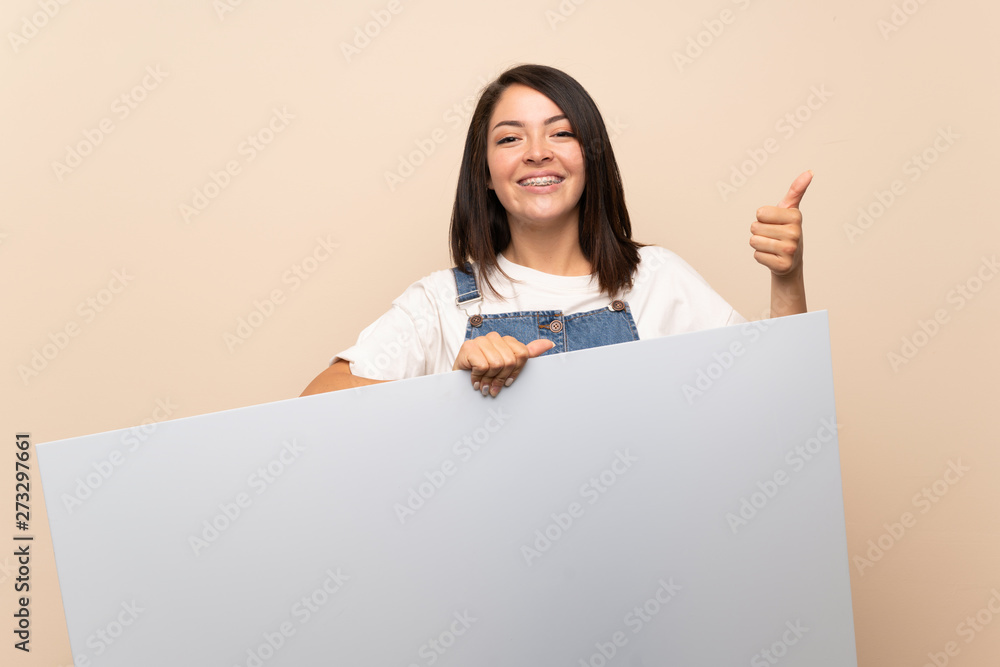 Young Mexican woman over isolated background holding an empty white placard for insert a concept Young Mexican woman over isolated background holding an empty white placard for insert a concept
