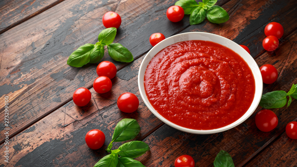 Homemade tomato Passata in white bowl on wooden table Homemade tomato Passata in white bowl on wooden table