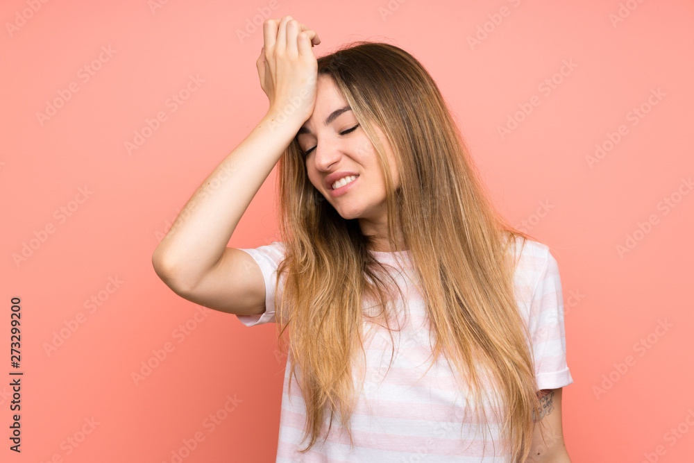 Young woman over isolated pink wall having doubts with confuse face expression