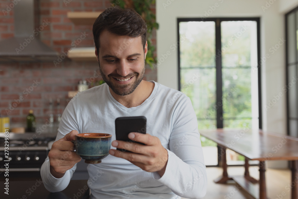Man with coffee cup using mobile phone Man with coffee cup using mobile phone