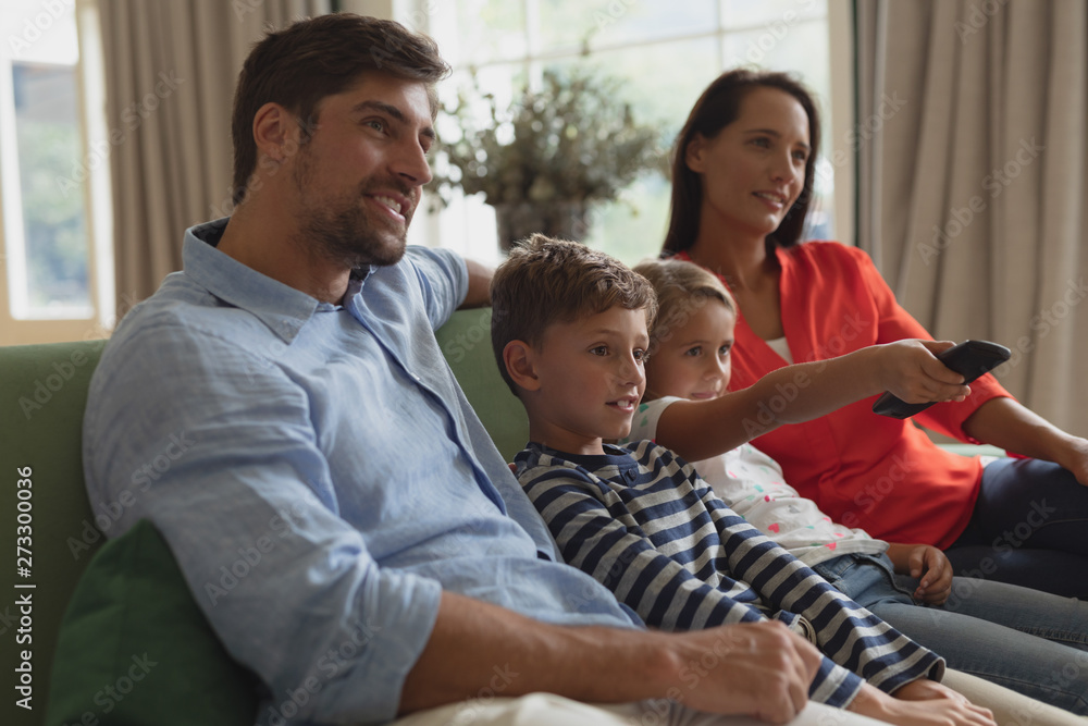 Obraz premium Family watching television in living room at home